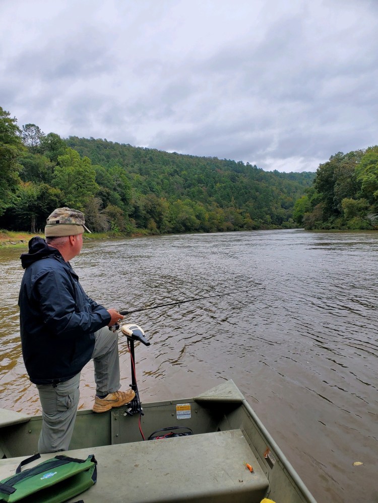 navigating boat on the Flint River