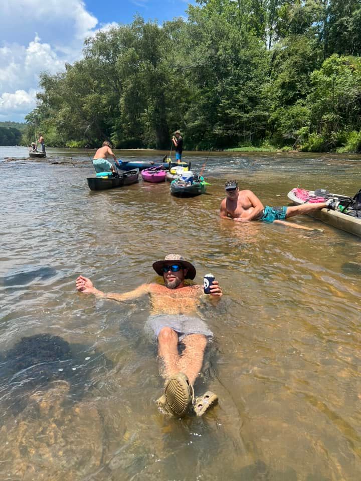 guys drinking beers and sunbathing in Flint River